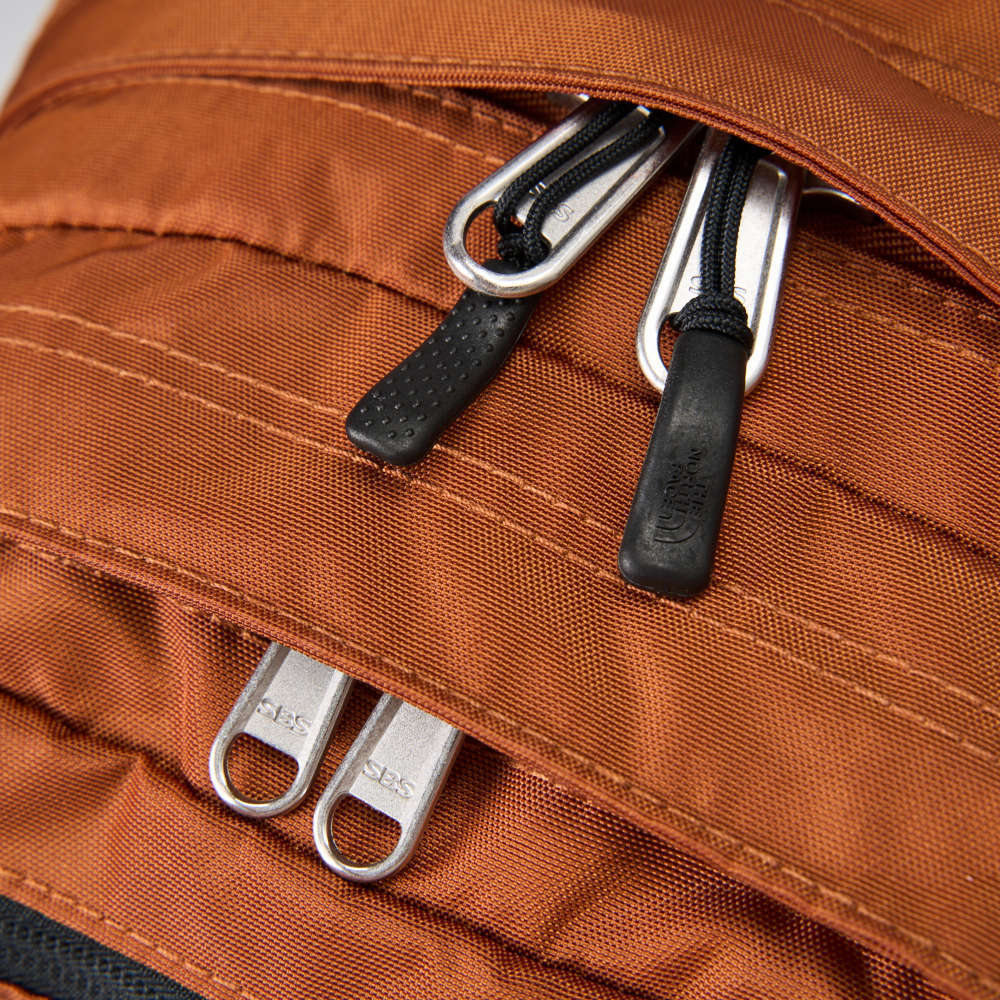 The North Face北面男女款橘色DWR防潑水休閒後背包｜CF9CC79